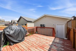 Wood deck with a red-stained finish and matching wood railings - 