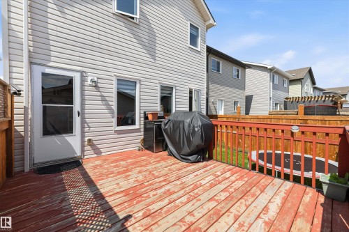 Rear wood deck with red-stained railing and light gray siding - 1563 Tamarack Boulevard Nw, Edmonton, AB - Outdoor With Deck Patio Veranda With Exterior