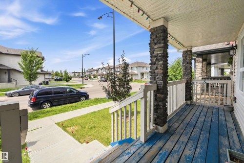 Front porch featuring stacked stone columns and a paneled ceiling - 1563 Tamarack Boulevard Nw, Edmonton, AB - Outdoor With Deck Patio Veranda