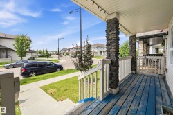Front porch featuring stacked stone columns and a paneled ceiling - 