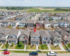 Residential neighborhood with diverse single-family homes, paved streets, and green spaces - 