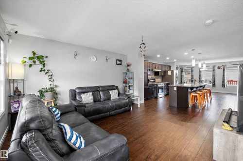 Open-concept living space featuring wood-finish flooring - 1563 Tamarack Boulevard Nw, Edmonton, AB - Indoor Photo Showing Living Room