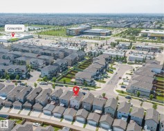 Aerial perspective showcasing a residential neighborhood with a variety of housing styles, including multi-story detached homes and townhouses - 