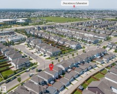 Aerial perspective showcasing a residential area with a prominent city skyline in the distance - 
