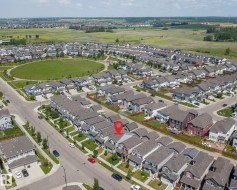 Residential property situated within a developed community featuring a central green space - 