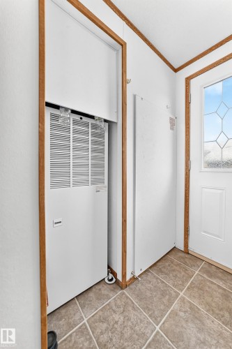 Utility closet featuring a white furnace unit with a visible air intake vent, accompanied by a white electrical panel - #225 3400 48 St, Stony Plain, AB - Indoor Photo Showing Other Room