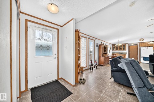 Entryway featuring a white door with decorative glass inserts, wood-finish trim, and a flush-mount ceiling light - #225 3400 48 St, Stony Plain, AB - Indoor Photo Showing Other Room