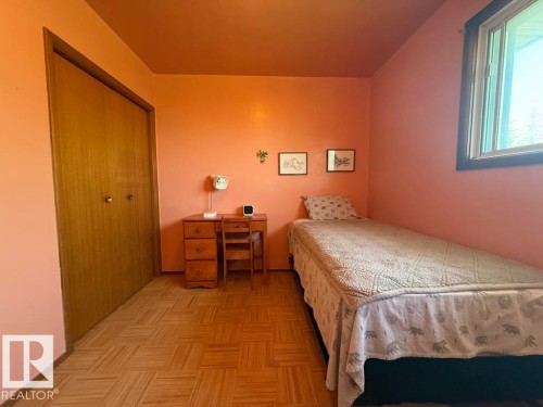 Hardwood flooring in a basketweave pattern - 9908 96A Avenue, Fort Saskatchewan, AB - Indoor Photo Showing Bedroom