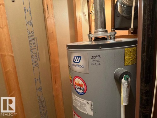 Utility space featuring a John Wood water heater and visible wall framing with Westroc gypsum board - 9908 96A Avenue, Fort Saskatchewan, AB - Indoor Photo Showing Basement