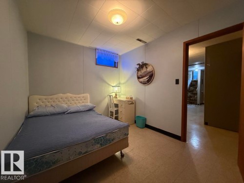 Compact room featuring light-colored walls and a drop ceiling - 9908 96A Avenue, Fort Saskatchewan, AB - Indoor Photo Showing Bedroom