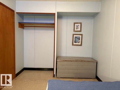 Integrated closet storage featuring an upper shelf and hanging rod - 9908 96A Avenue, Fort Saskatchewan, AB - Indoor Photo Showing Other Room