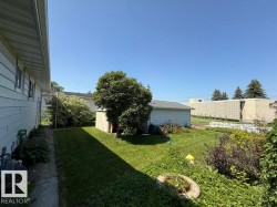 Expansive grassy lawn area with perimeter landscaping - 
