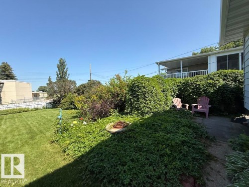 Expansive green lawn with a white picket fence perimeter - 9908 96A Avenue, Fort Saskatchewan, AB - Outdoor
