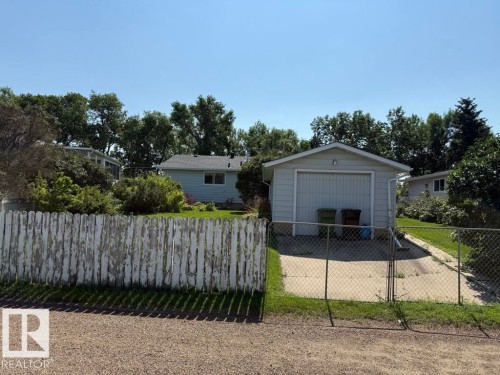 Detached garage with a roll-up door and concrete driveway - 9908 96A Avenue, Fort Saskatchewan, AB - Outdoor