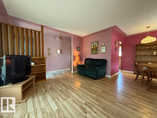 Open-concept living area featuring wood-finish flooring throughout - 9908 96A Avenue, Fort Saskatchewan, AB - Indoor Photo Showing Living Room