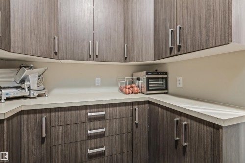 Walk-in Pantry featuring upper and lower cabinetry, conveniently located between the kitchen and attached garage - 1421 Westerra Bay, Stony Plain, AB - Indoor Photo Showing Kitchen