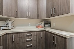 Walk-in Pantry featuring upper and lower cabinetry, conveniently located between the kitchen and attached garage - 