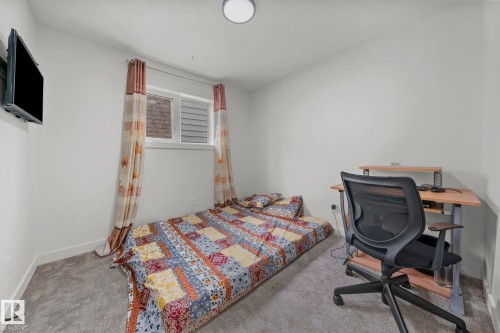 Carpeted room featuring a white ceiling with a flush-mount light fixture - 4119 18 Avenue Nw, Edmonton, AB - Indoor Photo Showing Bedroom