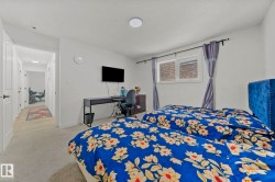 Spacious room featuring light gray carpeting, a single window with a privacy blind, and a recessed ceiling light fixture - 