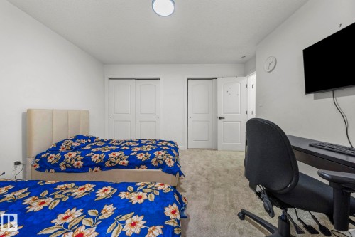 Carpeted room featuring a ceiling-mounted light fixture and white walls - 4119 18 Avenue Nw, Edmonton, AB - Indoor Photo Showing Bedroom