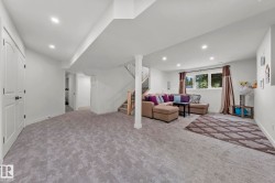 Lower level featuring light gray patterned carpeting, recessed lighting, and a white interior color palette - 