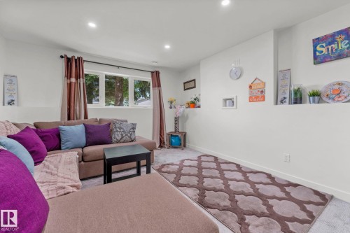 Carpeted living space featuring recessed lighting and a window with exterior views - 4119 18 Avenue Nw, Edmonton, AB - Indoor Photo Showing Living Room