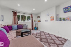 Carpeted living space featuring recessed lighting and a window with exterior views - 