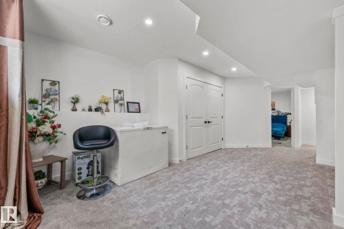 Spacious finished room featuring light gray patterned carpeting, recessed ceiling lighting, and crisp white walls - 4119 18 Avenue Nw, Edmonton, AB - Indoor
