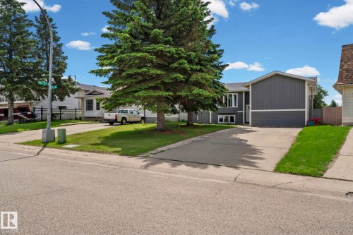 Split-level residence featuring gray siding, a two-car garage, and a concrete driveway - 4119 18 Avenue Nw, Edmonton, AB - Outdoor With Facade