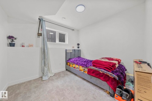 Carpeted room featuring a window, built-in shelving, and recessed lighting - 4119 18 Avenue Nw, Edmonton, AB - Indoor Photo Showing Bedroom