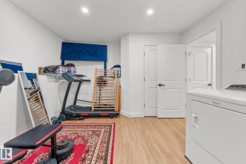 Bright interior space featuring light wood-finish flooring, recessed lighting, and white walls - 4119 18 Avenue Nw, Edmonton, AB - Indoor Photo Showing Gym Room