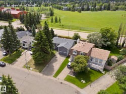 Property featuring a mature tree-lined street and landscaped grounds - 