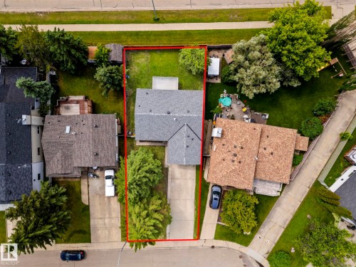 Aerial view of a residential property with a gray shingle roof, a paved driveway, and a partially grassed front yard - 4119 18 Avenue Nw, Edmonton, AB - Outdoor