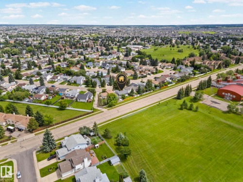 Aerial perspective showcasing a residential neighborhood with extensive green spaces and mature tree coverage - 4119 18 Avenue Nw, Edmonton, AB - Outdoor With View