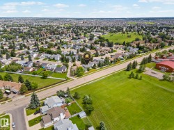 Aerial perspective showcasing a residential neighborhood with extensive green spaces and mature tree coverage - 