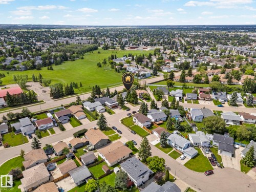 Residential area featuring a mix of single-family homes and multi-story buildings, bordered by extensive green spaces - 4119 18 Avenue Nw, Edmonton, AB - Outdoor With View