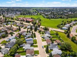 Residential neighborhood featuring detached homes and ample green spaces - 