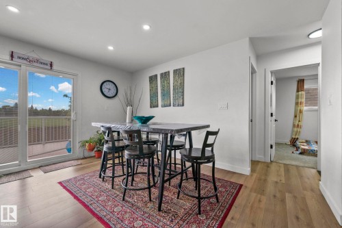 Bright living space featuring wood-finish flooring, recessed lighting, and white walls - 4119 18 Avenue Nw, Edmonton, AB - Indoor Photo Showing Dining Room