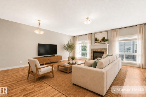 Photo has been virtually staged - #16 7293 South Terwillegar Dr Nw, Edmonton, AB - Indoor Photo Showing Living Room With Fireplace