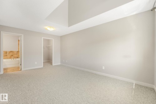 Spacious room with light-toned carpeting and neutral wall paint - #16 7293 South Terwillegar Dr Nw, Edmonton, AB - Indoor Photo Showing Other Room