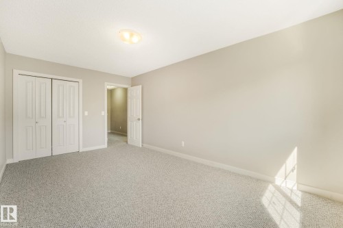 Spacious room with light neutral walls and gray patterned carpet - #16 7293 South Terwillegar Dr Nw, Edmonton, AB - Indoor