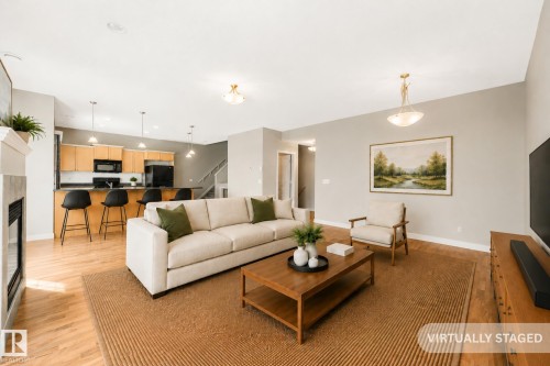 Photo has been virtually staged - #16 7293 South Terwillegar Dr Nw, Edmonton, AB - Indoor Photo Showing Living Room With Fireplace
