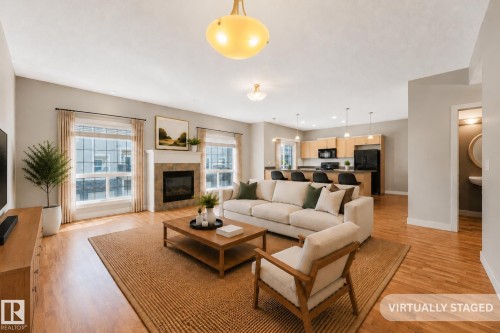 Photo has been virtually staged - #16 7293 South Terwillegar Dr Nw, Edmonton, AB - Indoor Photo Showing Living Room With Fireplace