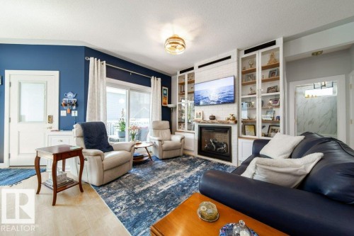 8731 85 Avenue Nw, Edmonton, AB - Indoor Photo Showing Living Room With Fireplace