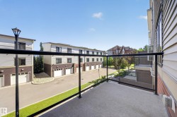 Balcony featuring a glass railing and concrete flooring - 