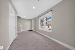 Carpeted room with neutral wall tones and white baseboards - 