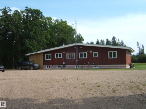 Ranch-style residence featuring brown wood siding and white trim - 151042 Twp  Rd 562, Rural Two Hills County, AB - Outdoor With Exterior