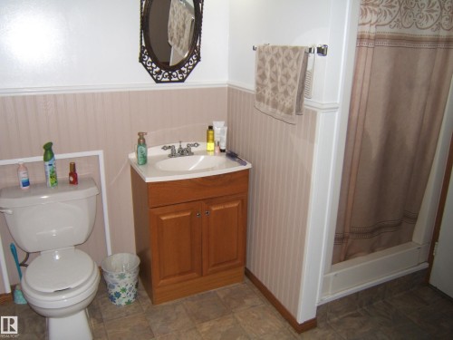 White vanity with an integrated sink and chrome faucet - 151042 Twp  Rd 562, Rural Two Hills County, AB - Indoor Photo Showing Bathroom