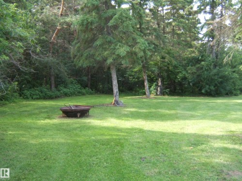 Expansive grassy area featuring a fire pit - 151042 Twp  Rd 562, Rural Two Hills County, AB - Outdoor