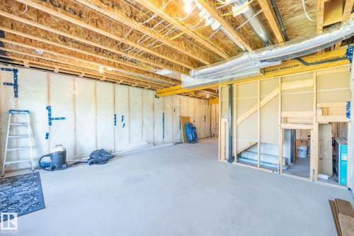 Unfinished basement featuring exposed wood joists, concrete flooring, and partial wall framing for future customization - 5403 Lark Landing Nw, Edmonton, AB - Indoor Photo Showing Basement